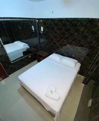 a white bed with a heart on it in a room at Hotel Rancho Grande in Barranquilla