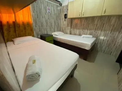 a small room with two beds in it at Hotel Rancho Grande in Barranquilla