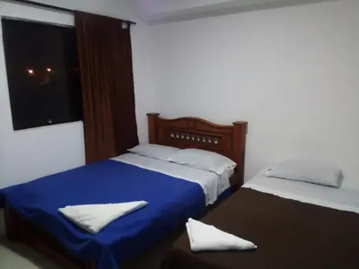 a bedroom with two beds and a window at Hotel Palma Real Cartagena in Cartagena de Indias