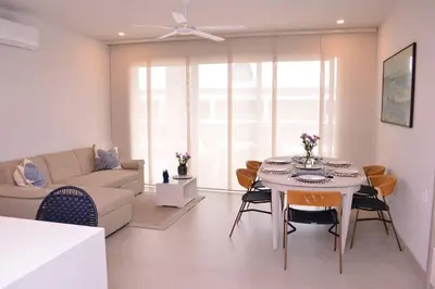 a living room with a table and a couch at Lujoso Penthouse - Vista al Mar - Playa Privada in Cartagena de Indias