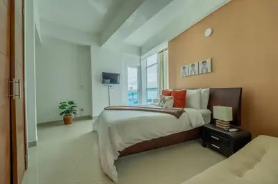 a bedroom with a large bed and a window at Un espacio sofisticado en medio de El Laguito Edificio Poseidon del Caribe in Cartagena de Indias