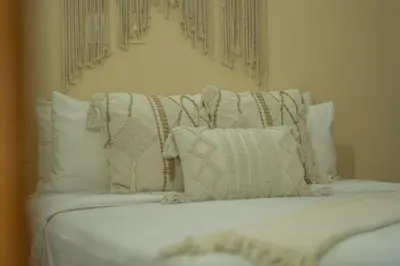 a white bed with white pillows on it at Un espacio sofisticado en medio de El Laguito Edificio Poseidon del Caribe in Cartagena de Indias