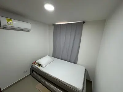 a small bed in a small room with a window at Apto amoblado en Alameda del Río in Barranquilla