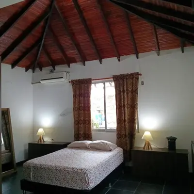 a bedroom with a bed and a window at Sharick Beach House in Tubará