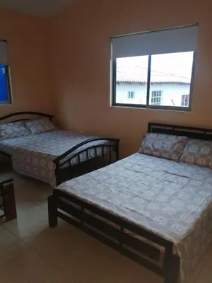 a bedroom with two beds and a window at Espectacular Cabaña en Santa Veronica in Santa Veronica