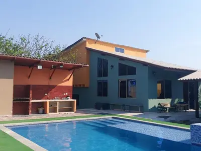 a house with a swimming pool in front of it at Espectacular Cabaña en Santa Veronica in Santa Veronica