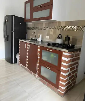 a kitchen with a sink and a refrigerator at Céntrico y confortable apto casa Doña yola 5 in Cartagena de Indias