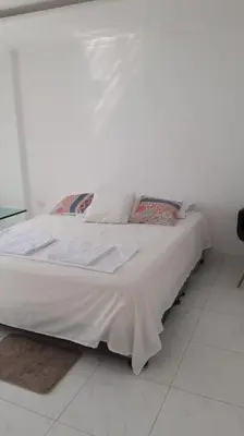a white bed in a room with a white floor at 360° Sea View Penthouse 17° floor, Cartagena in Cartagena de Indias