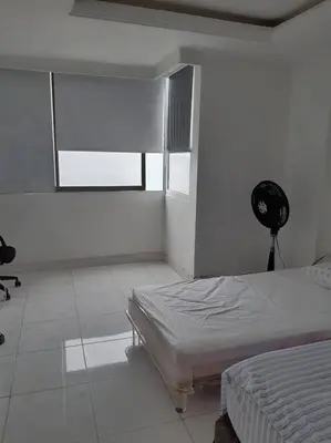 a white room with a bed and a fan at 360° Sea View Penthouse 17° floor, Cartagena in Cartagena de Indias