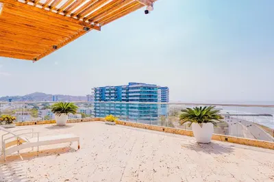 a balcony with potted plants and a view of the ocean at U-GO Ocean Drive: Apto Moderno con Balcón y Mar in Cartagena de Indias