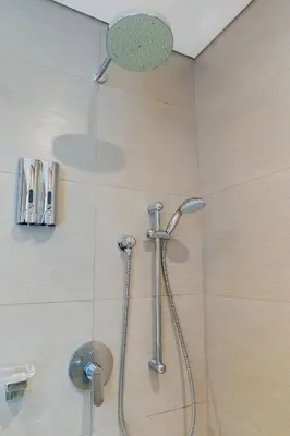 a shower with a shower head in a bathroom at U-GO Edificio H2 en Bocagrande Frente al Mar in Cartagena de Indias