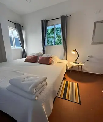 a bedroom with a large bed and a window at Céntrico y confortable apto Casa Doña yola 7 in Cartagena de Indias