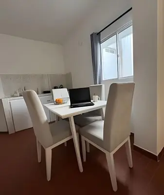 a white table with chairs and a laptop on it at Céntrico y confortable apto Casa Doña yola 7 in Cartagena de Indias