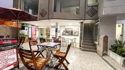 a restaurant with a table and chairs in front of it at Hotel & Restaurante Oasis CTG in Cartagena de Indias
