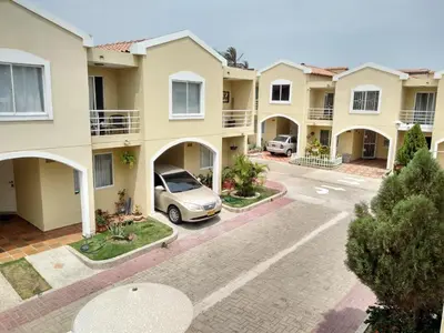 an apartment complex with a car parked in a parking lot at Habitacion Medusa in Barranquilla
