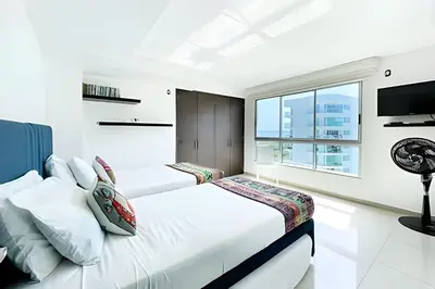 a bedroom with two beds and a window at Apartamento 2 Dormitorios Morros. Vista Mar in Cartagena de Indias