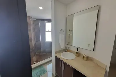 a bathroom with a sink and a mirror and a shower at Apartamento 2 Dormitorios Morros. Vista Mar in Cartagena de Indias