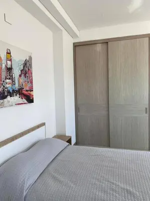 a bedroom with a bed and a painting on the wall at Apartaestudio Jacuzzi Centro Comercial Gimnasio ALTOPRADO in Barranquilla