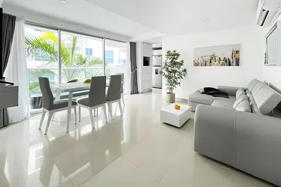 a white living room with a table and chairs at Apartamento 2 Dormitorios Morros. Salida playa in Cartagena de Indias