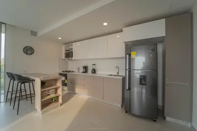 a kitchen with a stainless steel refrigerator and a counter at Encanto Rentals at Sunno Beach in Cartagena de Indias