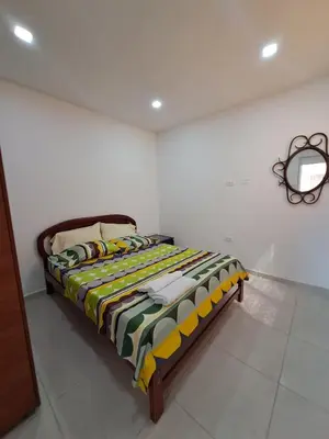 a bedroom with a bed with a colorful blanket at Cartagena más cómoda y económica in Cartagena de Indias