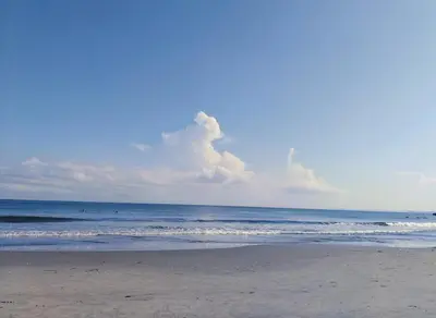 a beach with the ocean and clouds in the sky at Cartagena más cómoda y económica in Cartagena de Indias