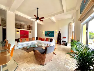 a living room with a couch and a ceiling fan at by Calamari Homes - Parque Centenario 206 walled city in Cartagena de Indias