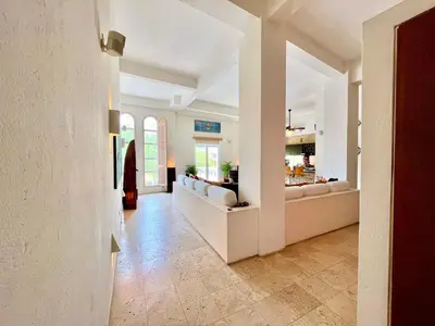 a large living room with white walls and tile floors at by Calamari Homes - Parque Centenario 206 walled city in Cartagena de Indias