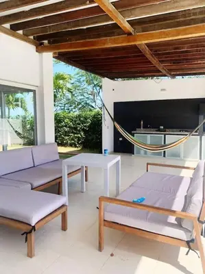 a patio with two couches and a hammock at Espectacular casa en oferta con piscina privada y vista al mar in Carretal