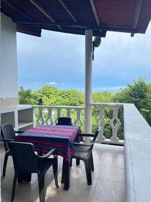 a table and chairs on a balcony with a view at Casa Majanicho in Rincón