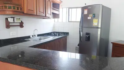 a kitchen with a stainless steel refrigerator and a sink at Cabaña La Pereztroica 1 in Coveñitas