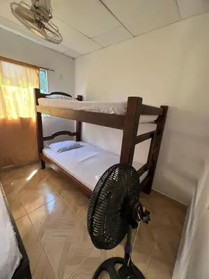 a room with two bunk beds and a fan at Apartamentos Coveñas TII in Coveñas