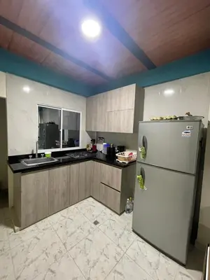 a kitchen with a refrigerator and a sink at Villa Carolina SM in Santa Marta