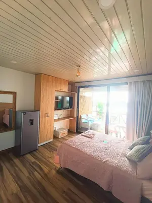a bedroom with a large bed and a large window at SUITE OCEAN VIEW - Playa in Tolú