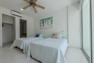 a bedroom with two beds and a ceiling fan at Edificio Morros 3 in Cartagena de Indias