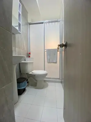 a bathroom with a toilet and a glass shower at Apartamento Cerca Playa Marbella in Cartagena de Indias