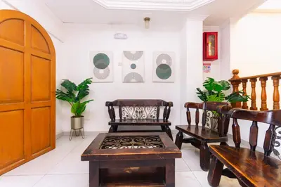 a room with a bench and a table and chairs at Hotel Med Cartagena in Cartagena de Indias
