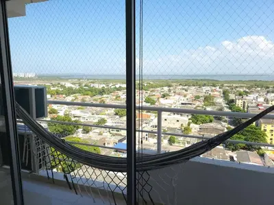 a hammock in a room with a view of a city at Great location close to airport in Cartagena de Indias