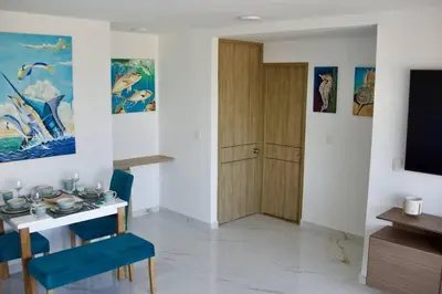 a dining room with a table and a television at Great location close to airport in Cartagena de Indias