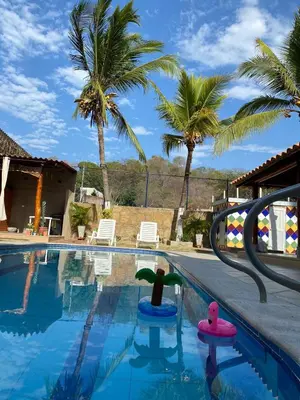 a swimming pool with two rubber ducks in the water at Palma House - Cabaña con piscina in Tubará