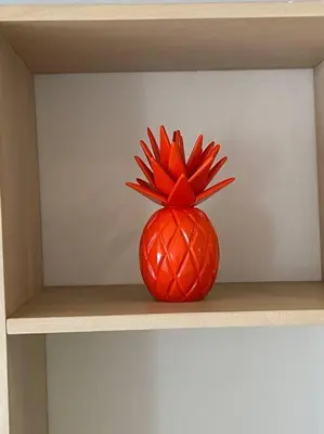 an orange pineapple is sitting on a shelf at Apartamento frente al Mar Cartagena in Cartagena de Indias