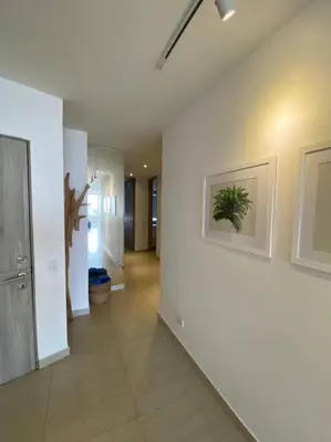 a hallway with white walls and a hallway with at Apartamento frente al Mar Cartagena in Cartagena de Indias