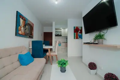 a living room with a couch and a flat screen tv at Apartamento El Colibri CARTAGENA en TORRE PRIMI in Cartagena de Indias