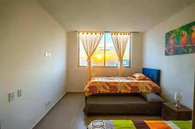a bedroom with a bed and a window at Exclusivo apartamento en Cielo Mar-playa las Americas, con maravillosas vistas del atardecer de Cartagena in Cartagena de Indias