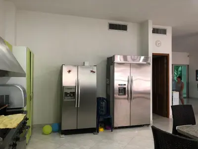 two stainless steel refrigerators are in a room at Cabañas Privadas en Playas del Francés con Piscina in San Silvestre