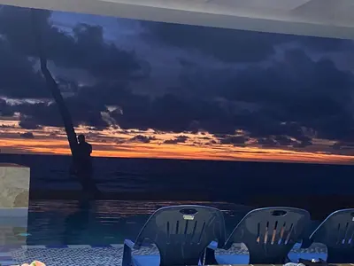 a wall with a painting of a man in the ocean at Cabañas Privadas en Playas del Francés con Piscina in San Silvestre