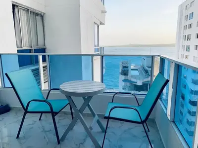 a table and chairs on a balcony with a view of the ocean at Apartamento Lindo en cartagena el laguito bocagrande con vista al mar in Cartagena de Indias
