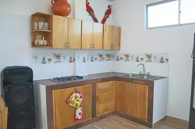 a kitchen with wooden cabinets and a sink at Apartamento Doña Flor in Coveñas