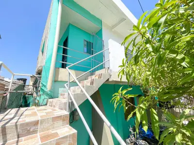 a blue and white house with stairs in front at Apartamento Doña Flor in Coveñas