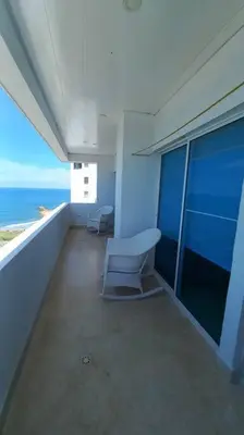 a room with two chairs and a view of the ocean at Penthouse en Cartagena in Cartagena de Indias